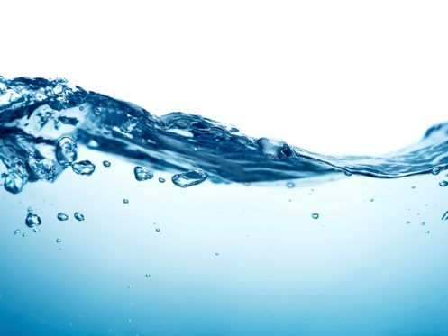 Clear blue hot water with small bubbles and ripples, photographed close up against a white background. The image captures the motion and fluidity of the water as it undulates, reminiscent of happy moments in households. | High 5 Plumbing, Heating & Cooling